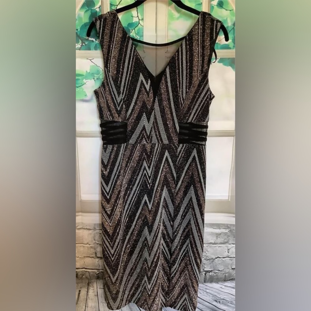 Women's Dress Size 6  Sexy sheer plunging inset and sheer waist sides.
